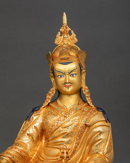 Close-up of Guru Padmasambhava sculpture showing intricate gold fire-gilded details