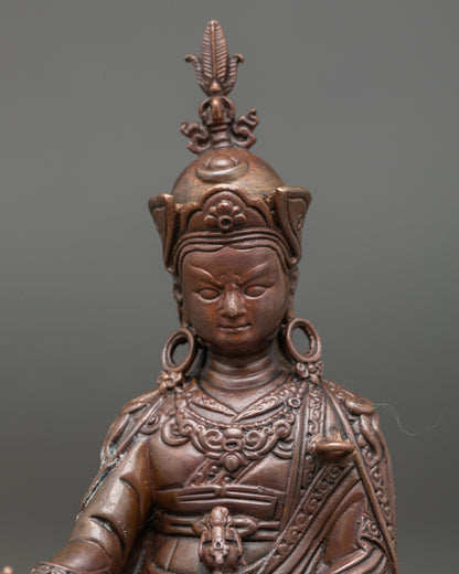 Close-up of Guru Rinpoche Statue showing detailed face and five-pronged vajra at heart