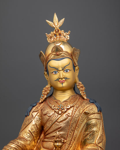 Close-up of Guru Rinpoche Statue with 24k Gold Gilded Face and Vajra in Hand