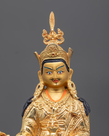 Close-up of Guru Rinpoche face with gold detailing and semi-precious stones