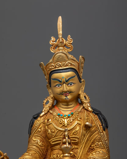 Close-up of Guru Rinpoche's face gilded in 24K gold with peaceful expression