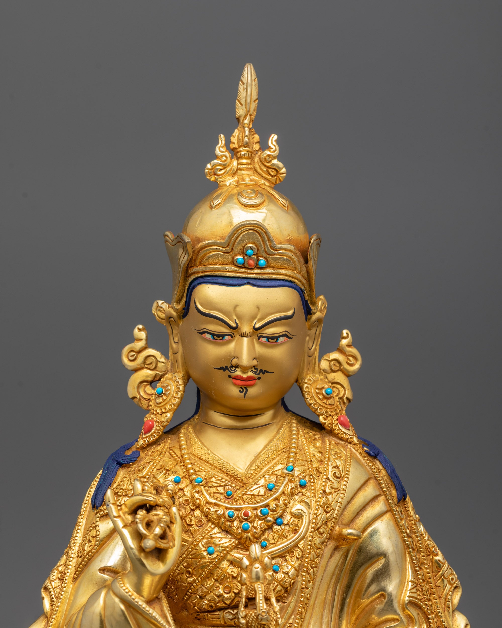 Close-up of Guru Rinpoche's face polished with pure 24k gold