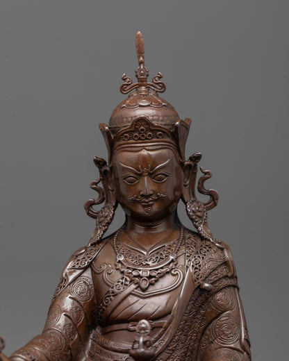 Close-up of Guru Rinpoche’s face with semi-wrathful expression and hands holding vajra