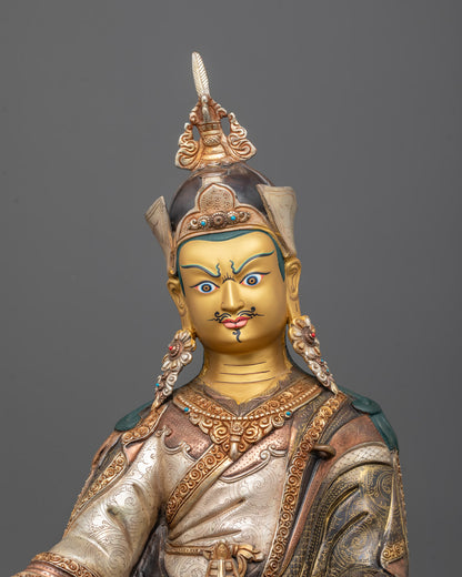 Close-up of Guru Rinpoche’s jewel-encrusted crown, vajra, skull cup, and sacred Tripitaka robes
