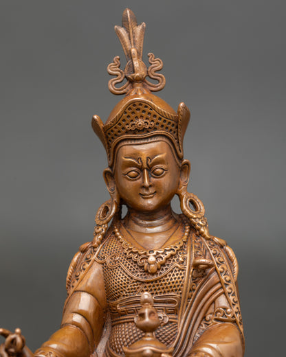 Close-up of Guru Rinpoche’s lotus hat and symbolic jewelry on oxidised Nepal statue