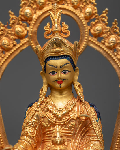 Close-up of Guru Rinpoche’s peaceful face and detailed 24k gold gilded copper