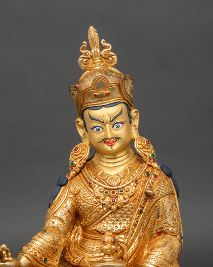 Close-up of Guru Rinpoche statue showing intricate lotus throne and vajra details
