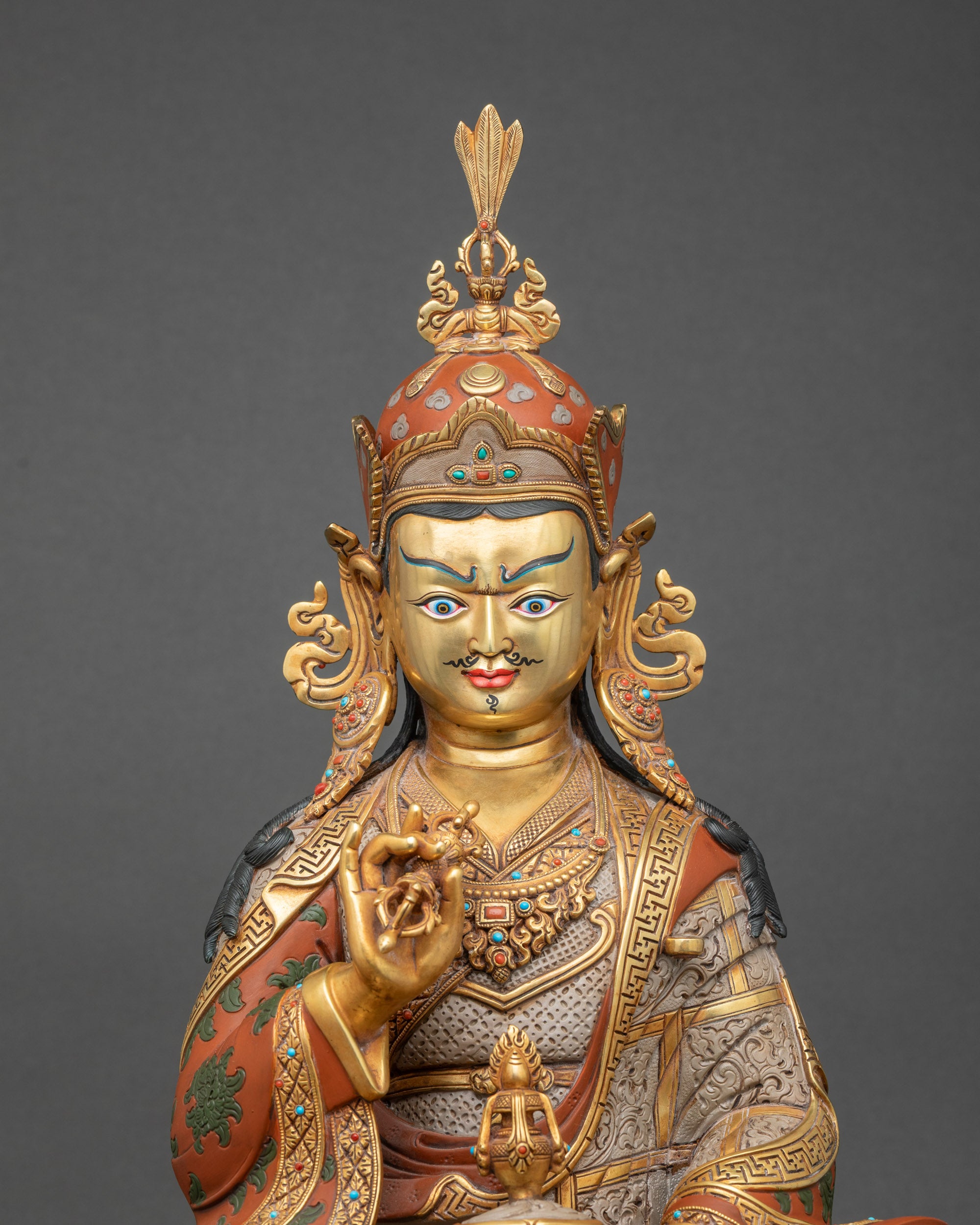 Close-up of Guru Tsokye Dorje statue with gold gilding and stone inlay