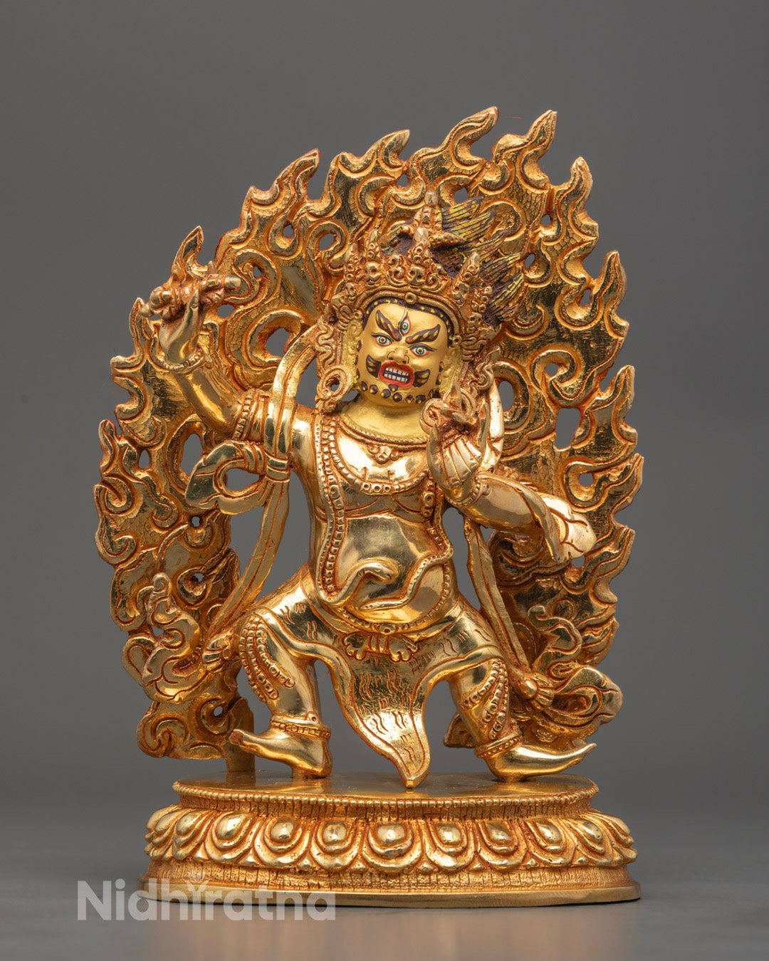 Vajrapani statue holding vajra, handcrafted in Nepal with 24k gold gilded copper and intricate facial features.