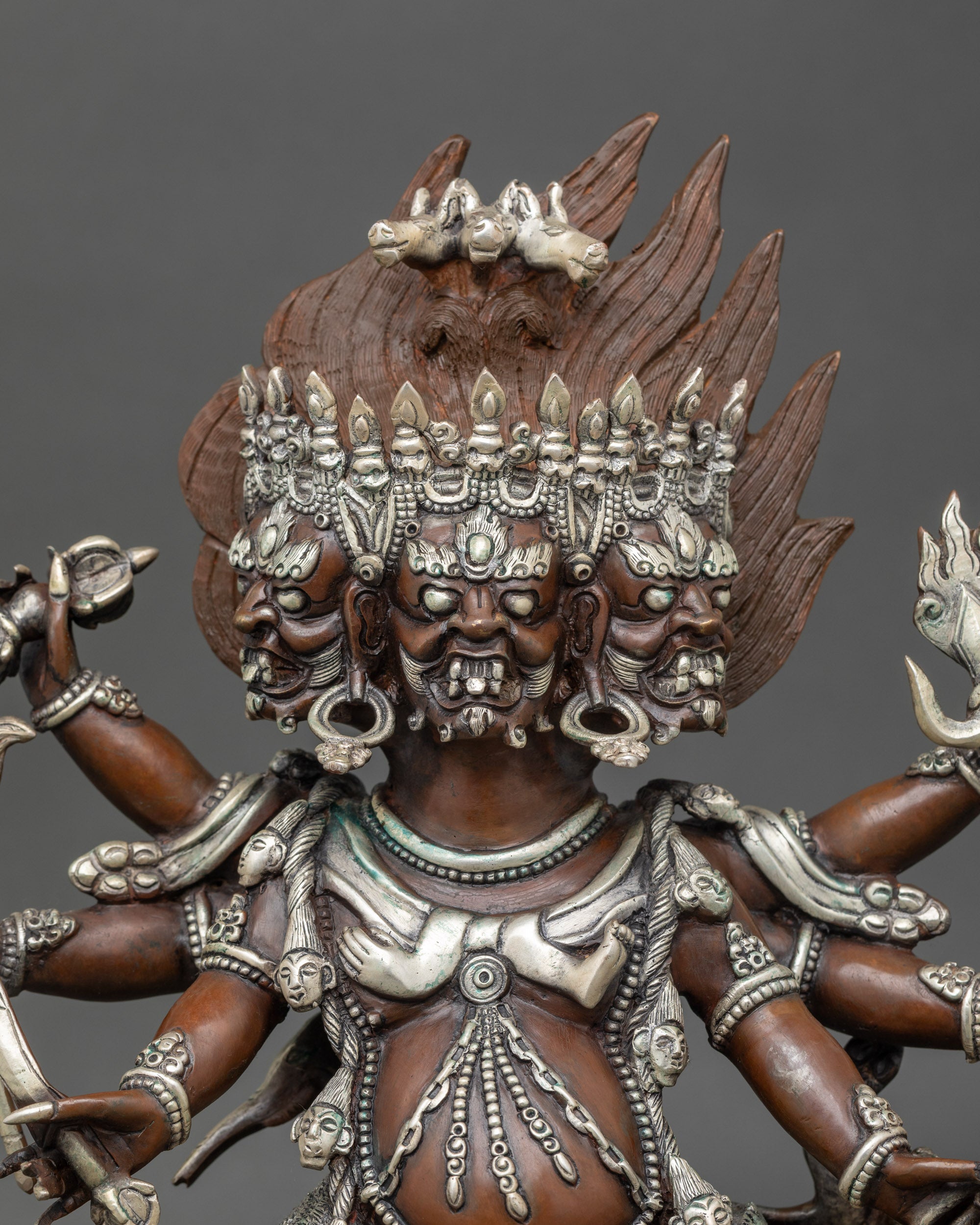 Close-up of Hayagriva deity face showing intricate Newari craftsmanship and silver-plated copper details