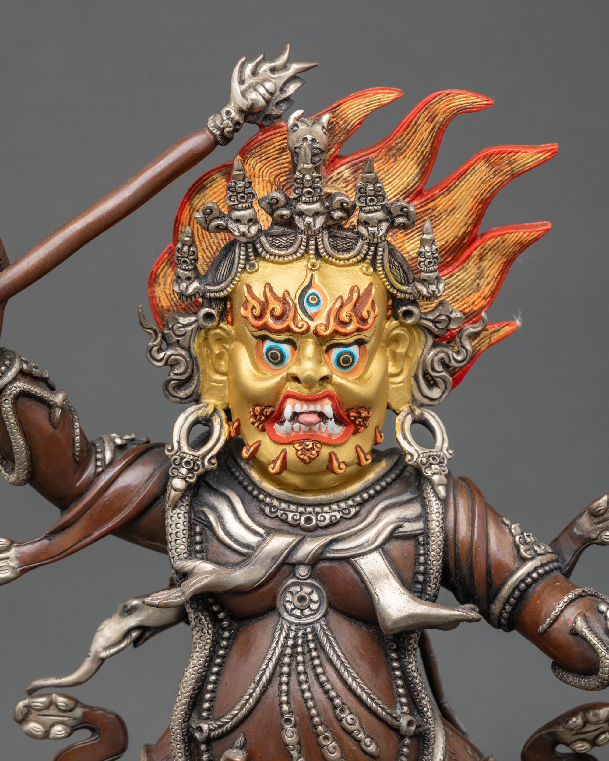 Close-up of Hayagriva face with deep brown oxidized finish and gold painted details
