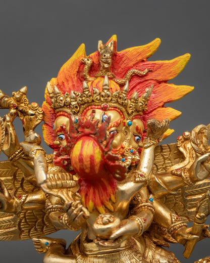 Close-up of Hayagriva gold-painted face with intricate jewelry and carved robe details