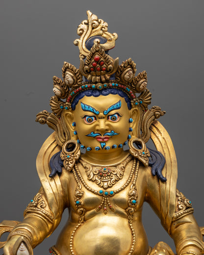 Jambhala statue adorned with semi-precious stones and detailed carvings.