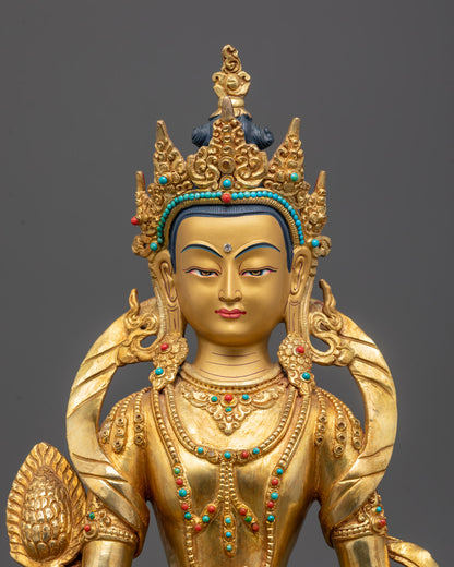 Close-up of Ksitigarbha statue’s calm face with gold gilded accents