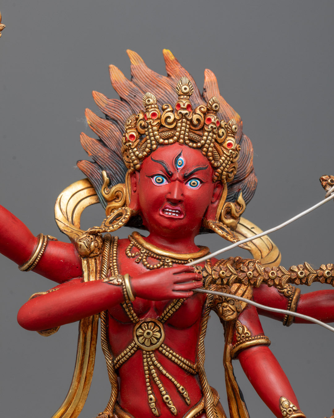 Close-up of Kurukulla statue’s face and upper body, showcasing fierce expression