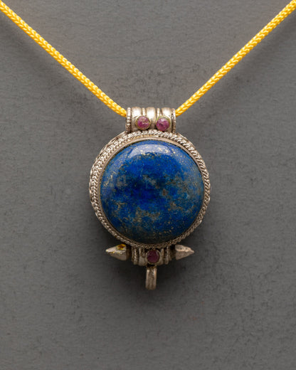Close-up of Lapis Lazuli stone and coral detailing on Tibetan silver locket pendant

