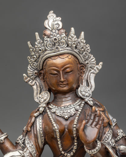 Close-up of Laxmi Statue showing four hands with lotus flower, pot of gold, and Varada Mudra