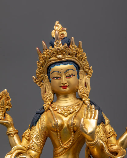 Close-up of Laxmi statue’s intricate crown and facial features in gold gilding