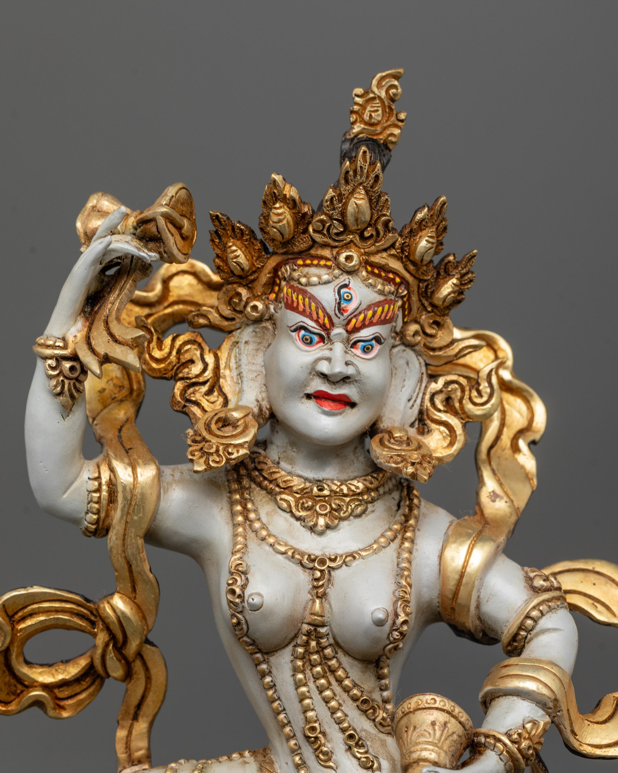 Close-up of Machig Labdron Idol showing hand drum, bell, crown, and intricate carvings