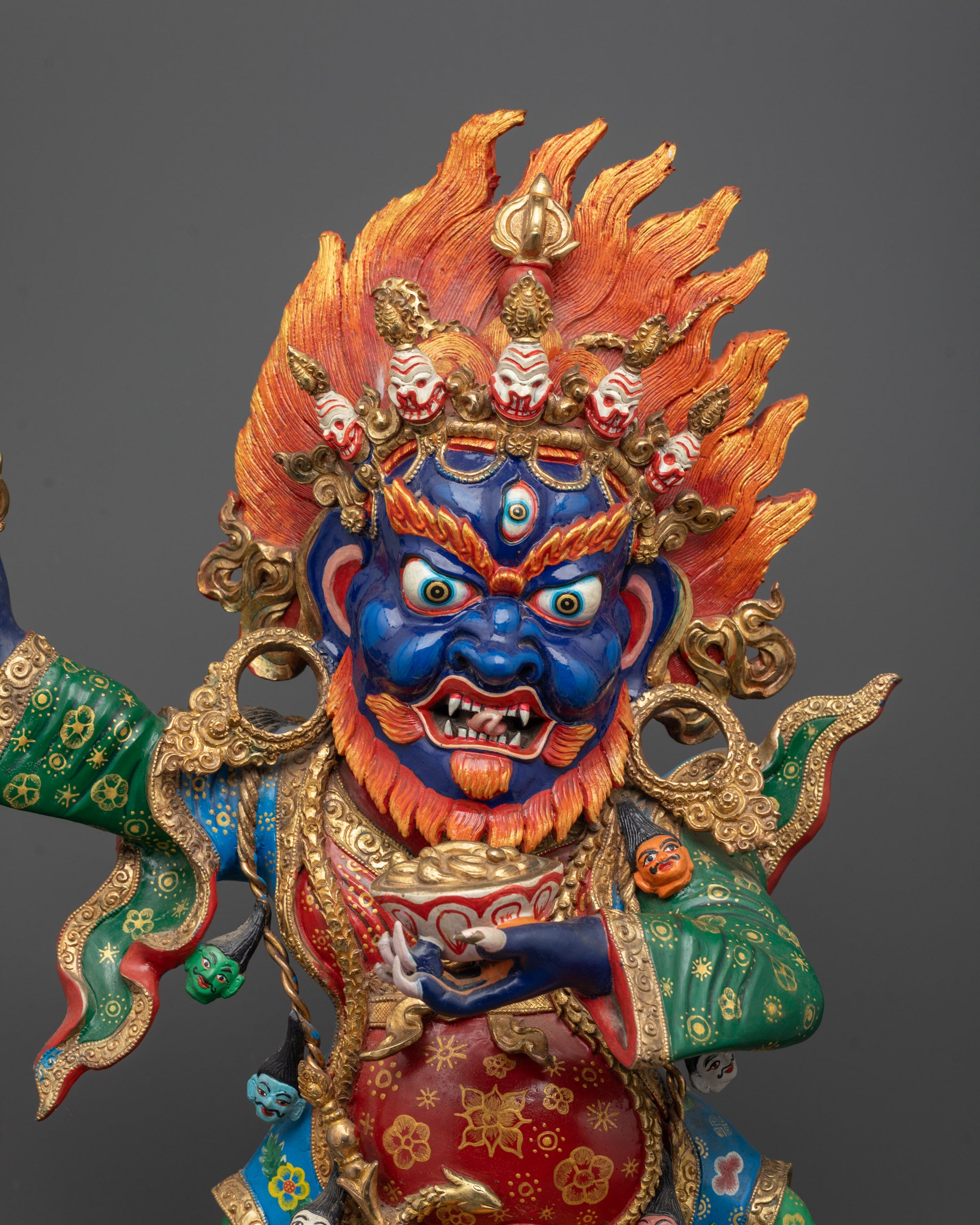Close-up of Mahakala Bernagchen holding curved knife with vajra holder