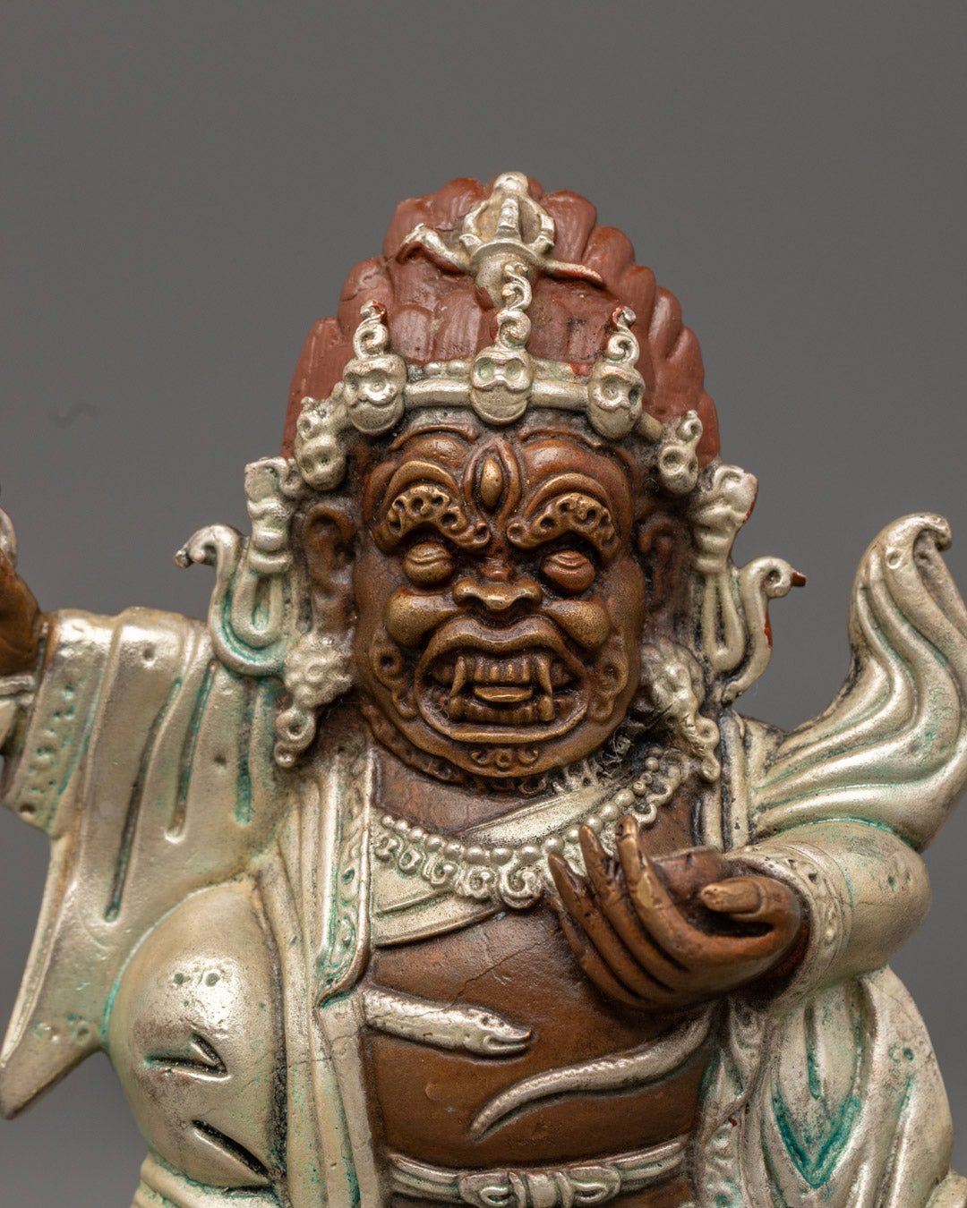 Mahakala Bernagchen’s fierce expression with skull crown, showcasing intricate hand-carved features and symbolic elements.