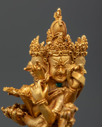 Close-up of Mahakala Bernagchen statue showing twelve arms and sacred implements on lotus seat