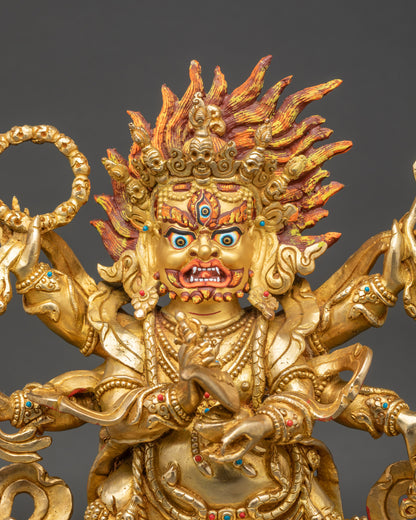 Close-up of Mahakala statue highlighting gold fire-gilded face and ornate details