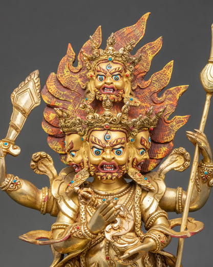 Close-up of Mahakala statue highlighting gold fire-gilded faces and ornate robes