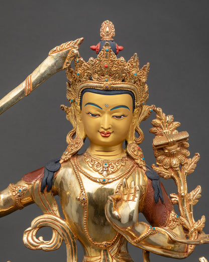 Close-up of Manjushri Bodhisattva face showing serene expression and gold accents