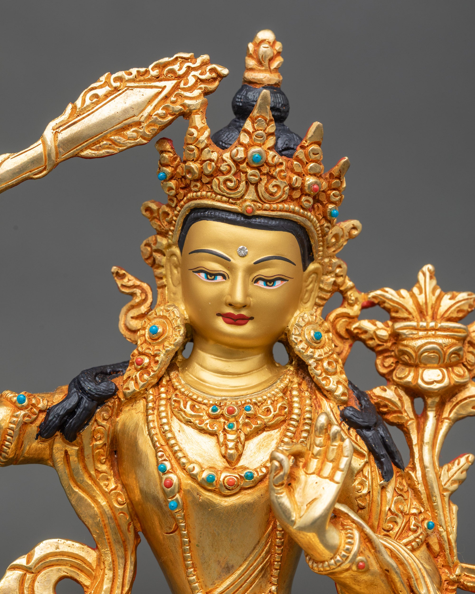 Close-up of Manjushri Bodhisattva holding a utpala flower and sword