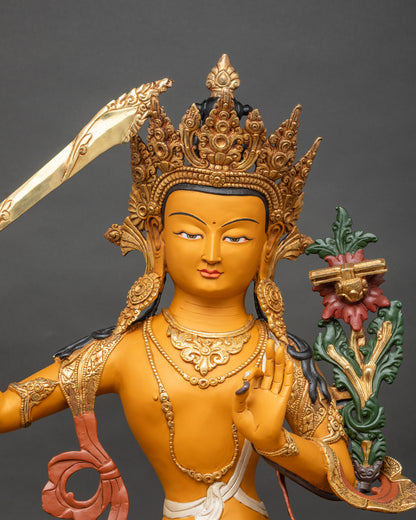 Close-up of Manjushri Bodhisattva statue showing gold-gilded details