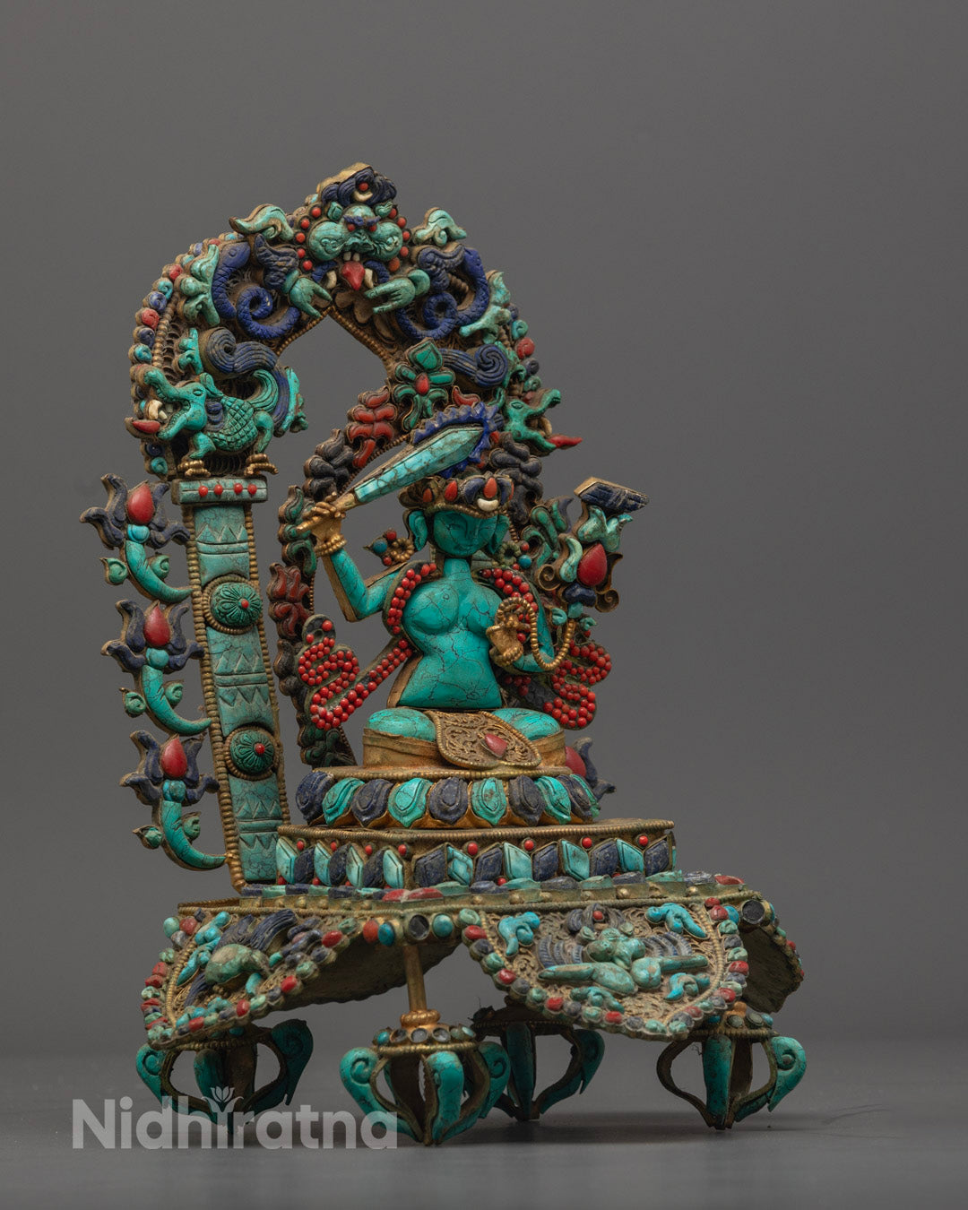 Manjushri Bodhisattva statue showing the flaming sword symbolizing wisdom cutting ignorance.