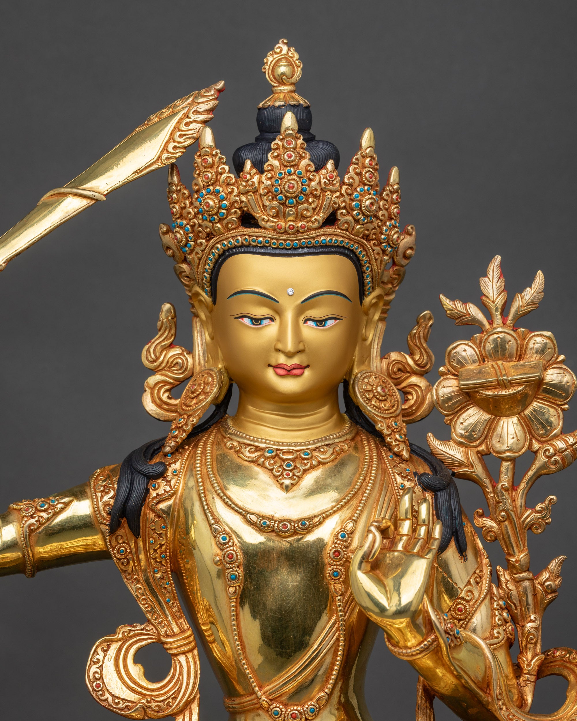 Close-up of Manjushri Statue showing gold-painted face and detailed craftsmanship