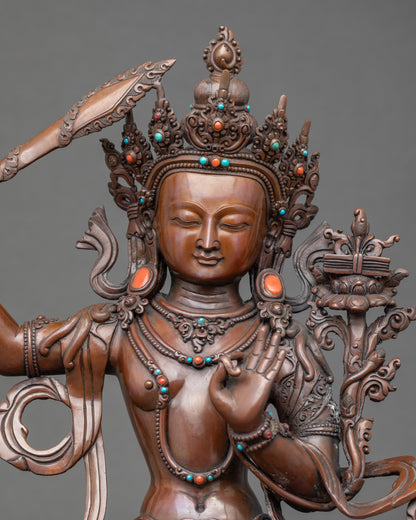 Close-up of Manjushri face and flaming sword, adorned with semi-precious stones