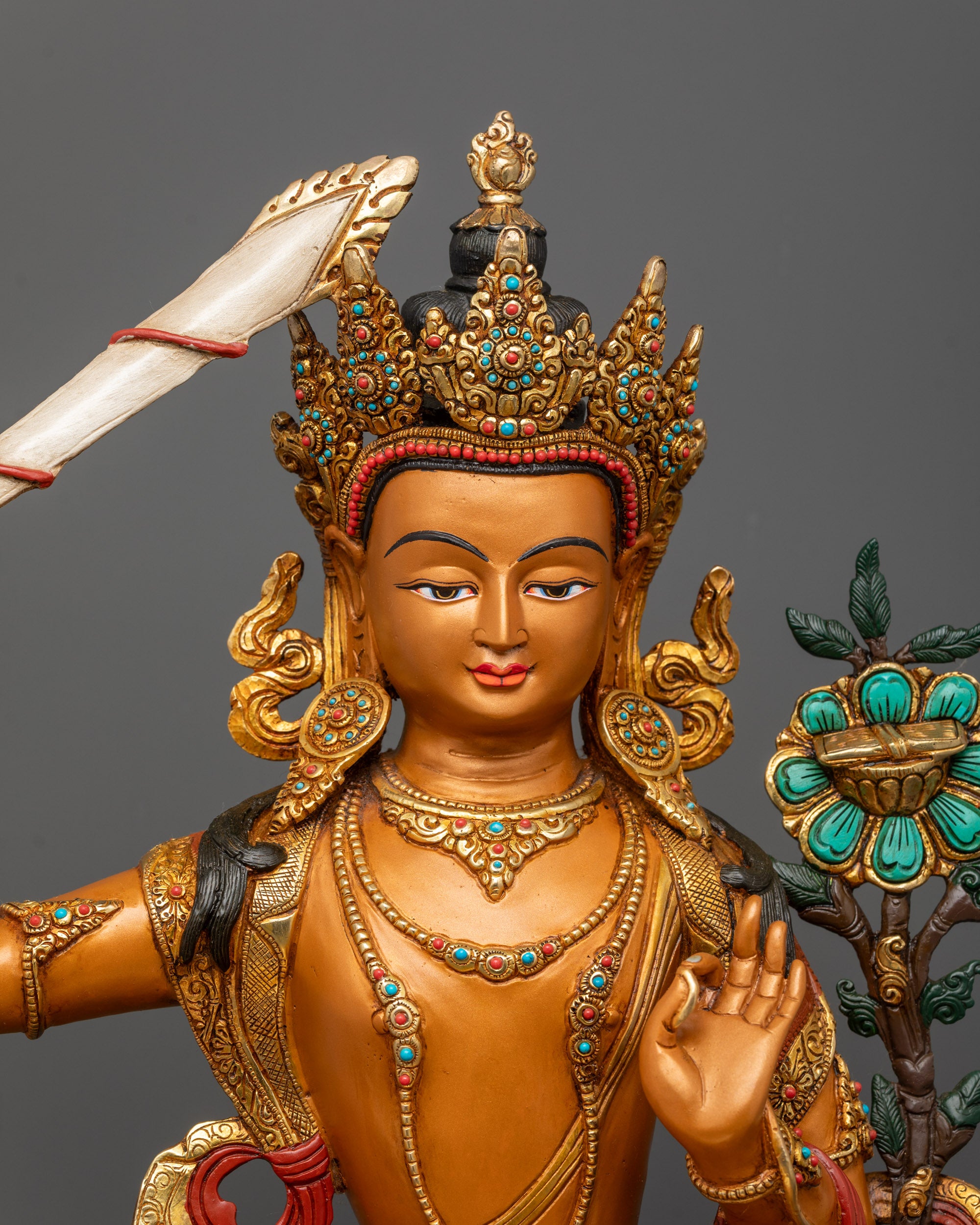 Close-up of Manjushri’s crown, jewelry, and flame of wisdom sword detailing