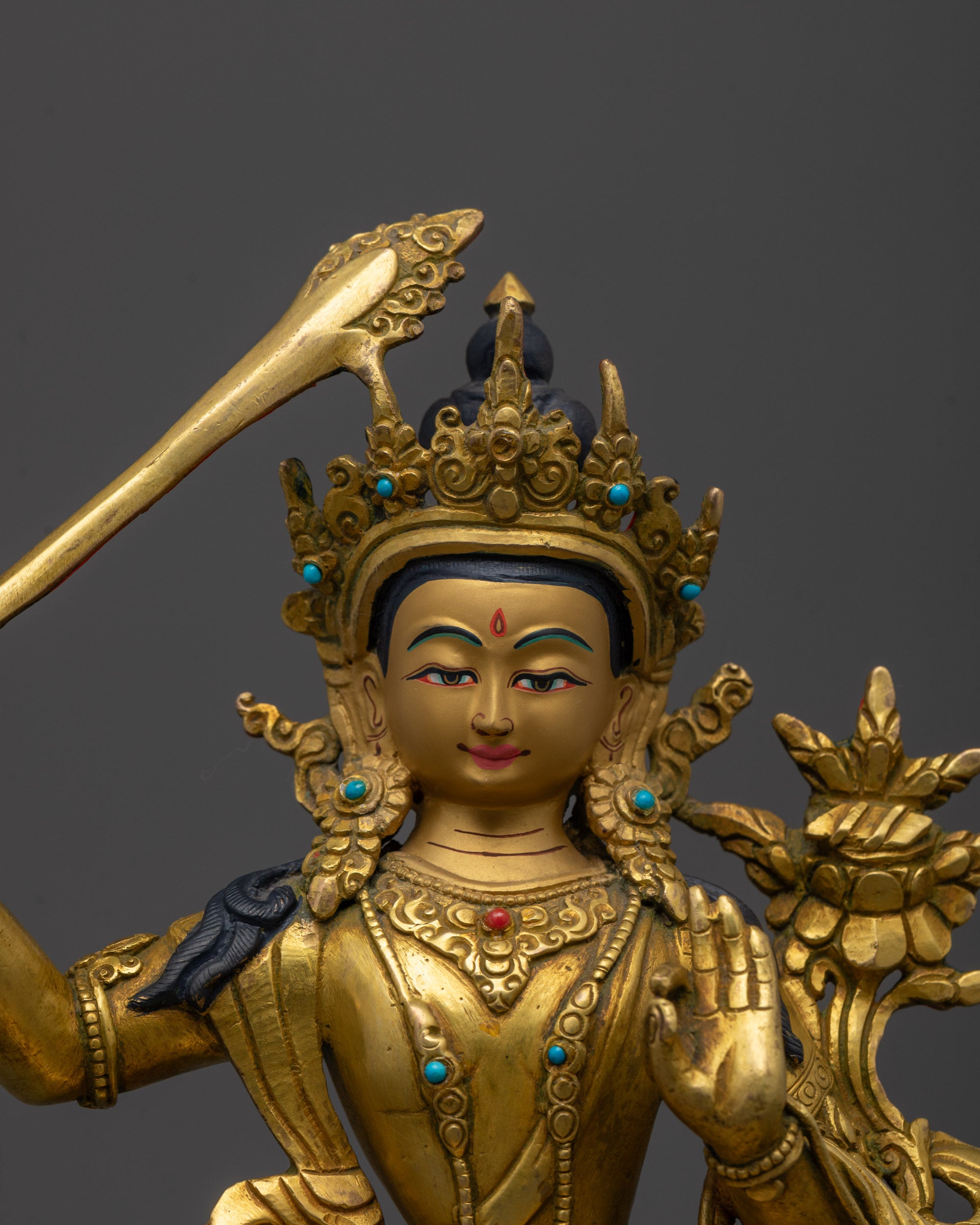 Close-up of Manjushri’s serene face and detailed crown, showcasing the artisan’s lost-wax technique