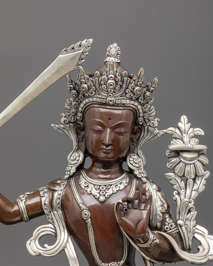 Close-up of Manjushri statue’s silver-plated sword, crown, and intricate carvings