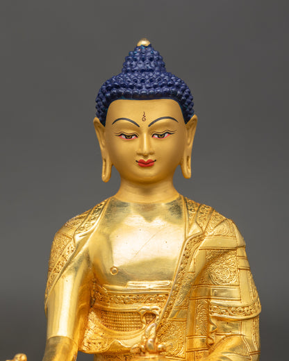 Close-up of Medicine Buddha Statue face showing gold electroplated details and serene expression