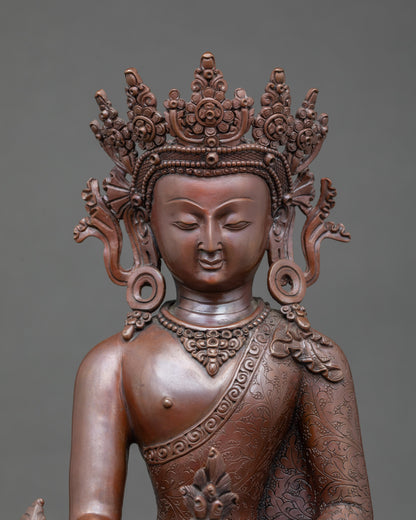 Close-up of Medicine Buddha holding myrobalan plant and healing nectar bowl, oxidized copper finish