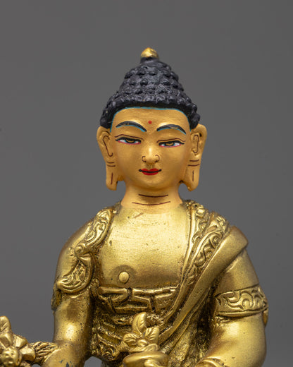 Close-up of Medicine Buddha with myrobalan and healing bowl in gold fire-gilded finish
