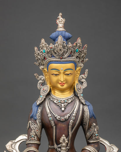 Close-up of Mitrugpa deity statue with dorje and semi-precious stone inlays