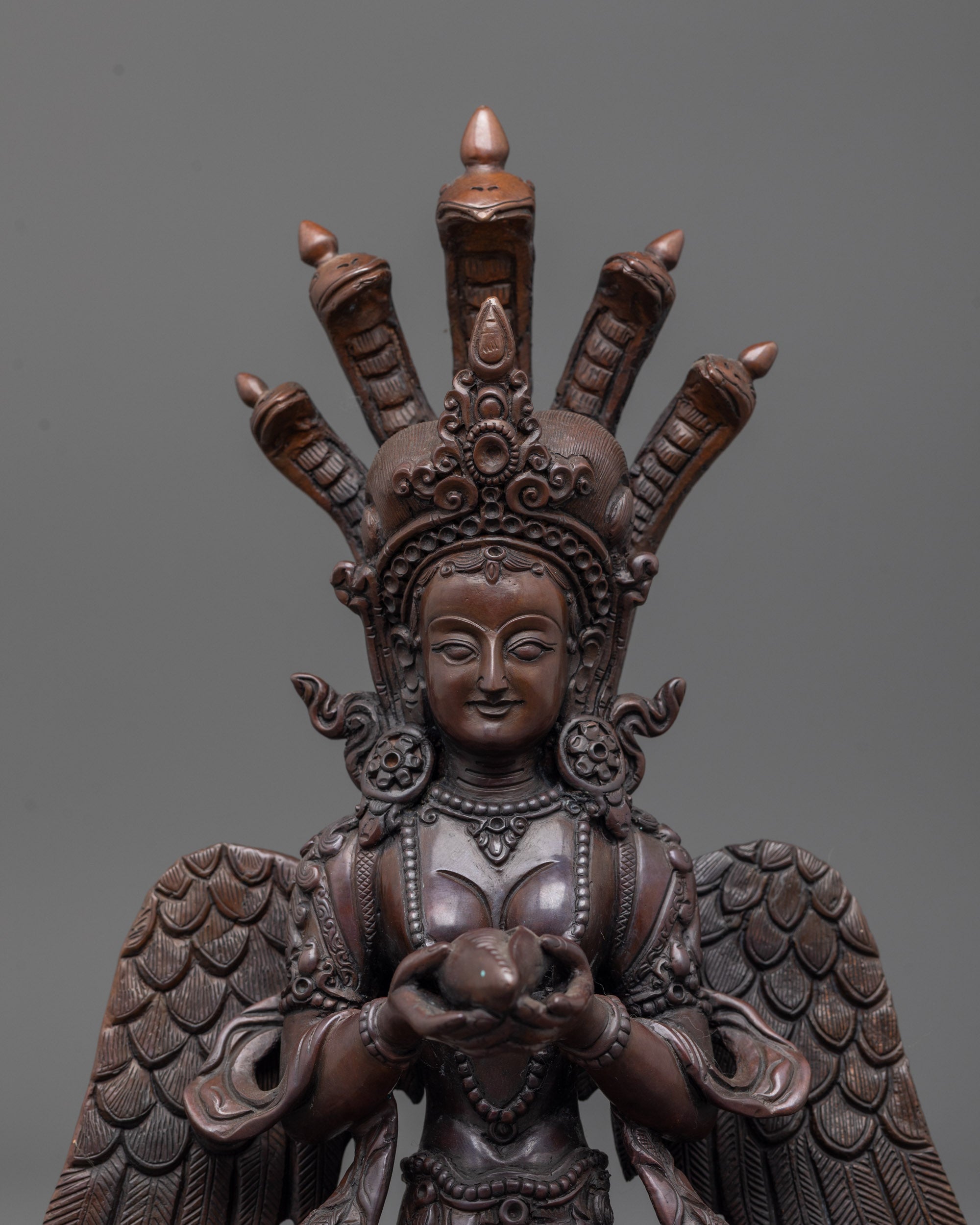 Close-up of Nagakanya Statue highlighting oxidized copper texture and hand-carved shell