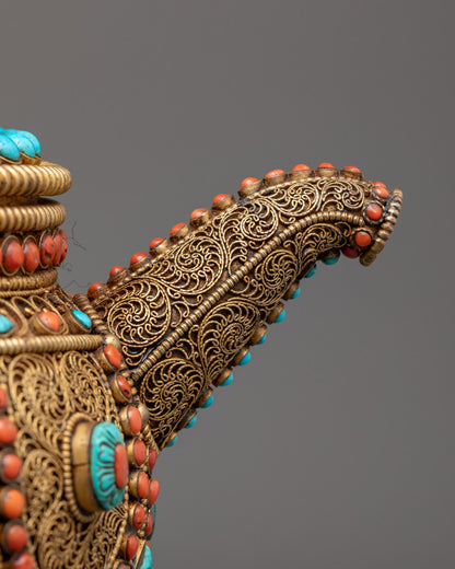 Close-up of Nepali ritual teapot's gold-plated details and semi-precious stones
