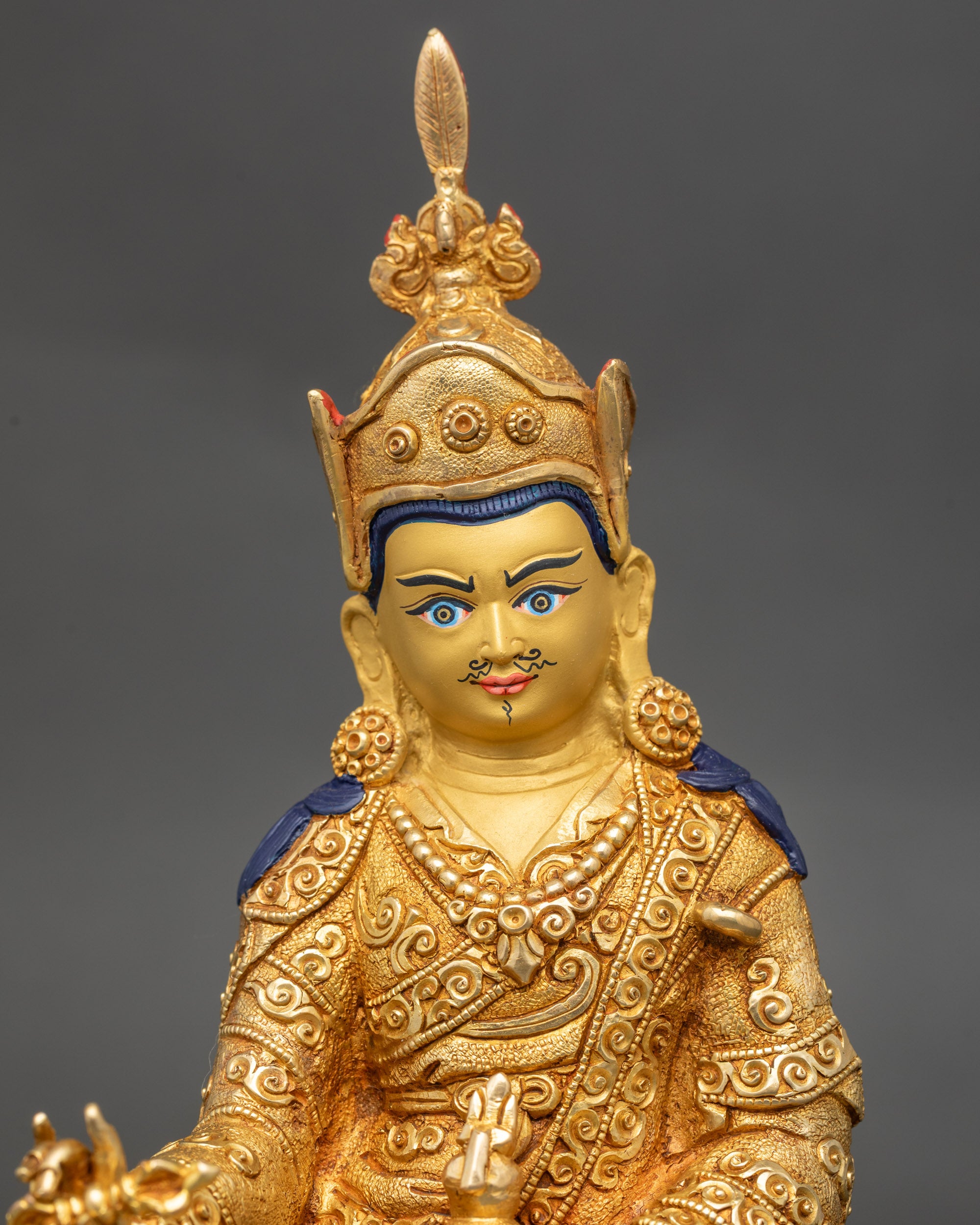 Close-up of Padmasambhava skull cup and dorje details on handcrafted statue