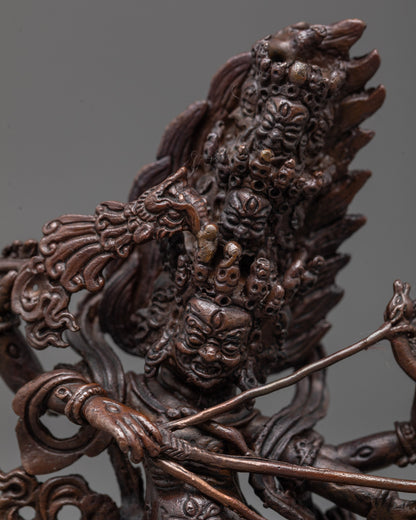 Close-up of Rahula Statue showing multiple fierce heads and detailed bow and arrow