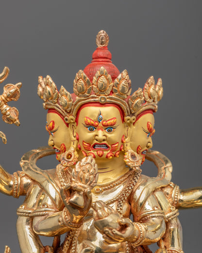Close-up of Red Dzambhala’s gold-plated copper body showing fierce expression