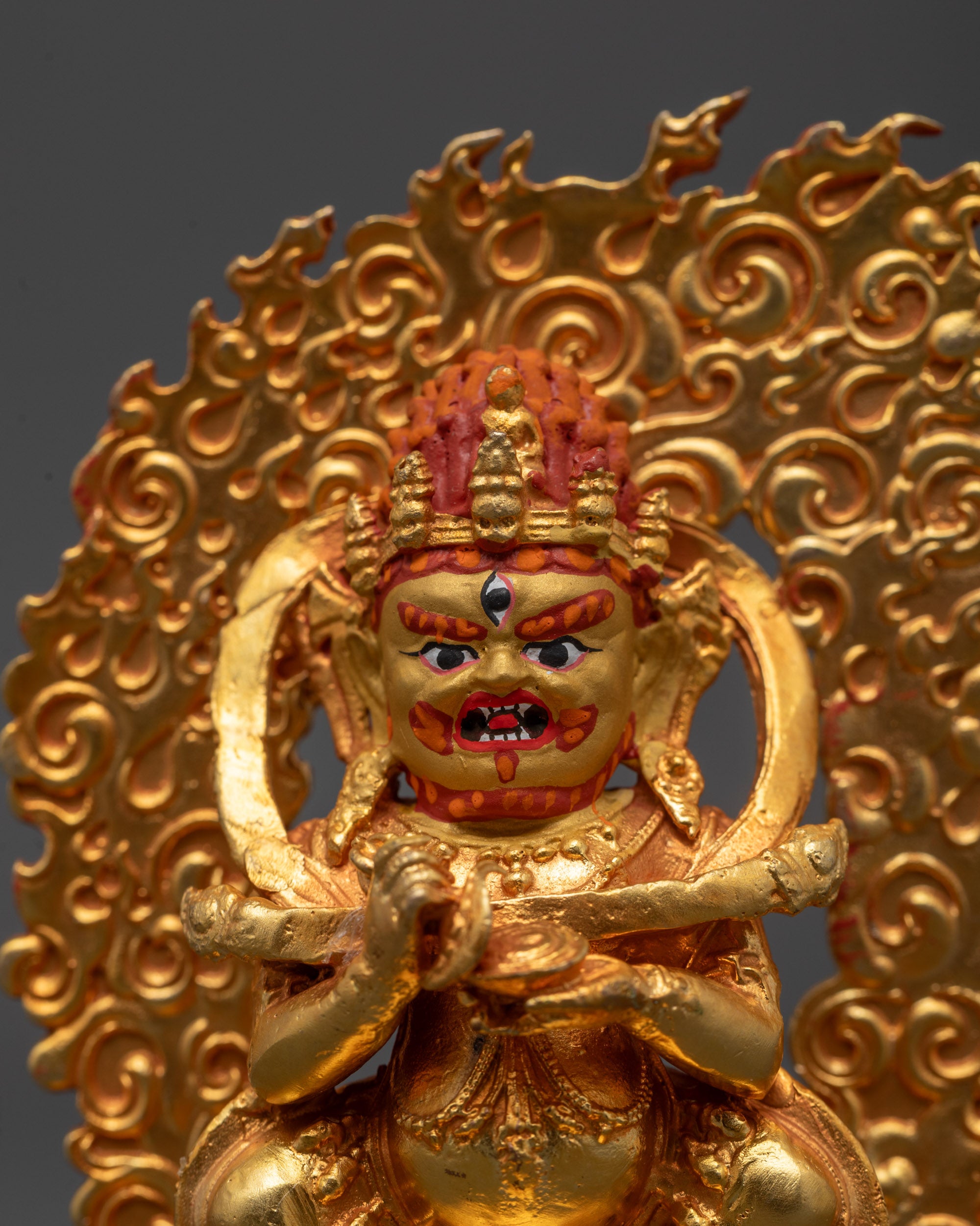 Close-up of Sakya Mahakala’s wrathful face and intricate details of gold-plated copper