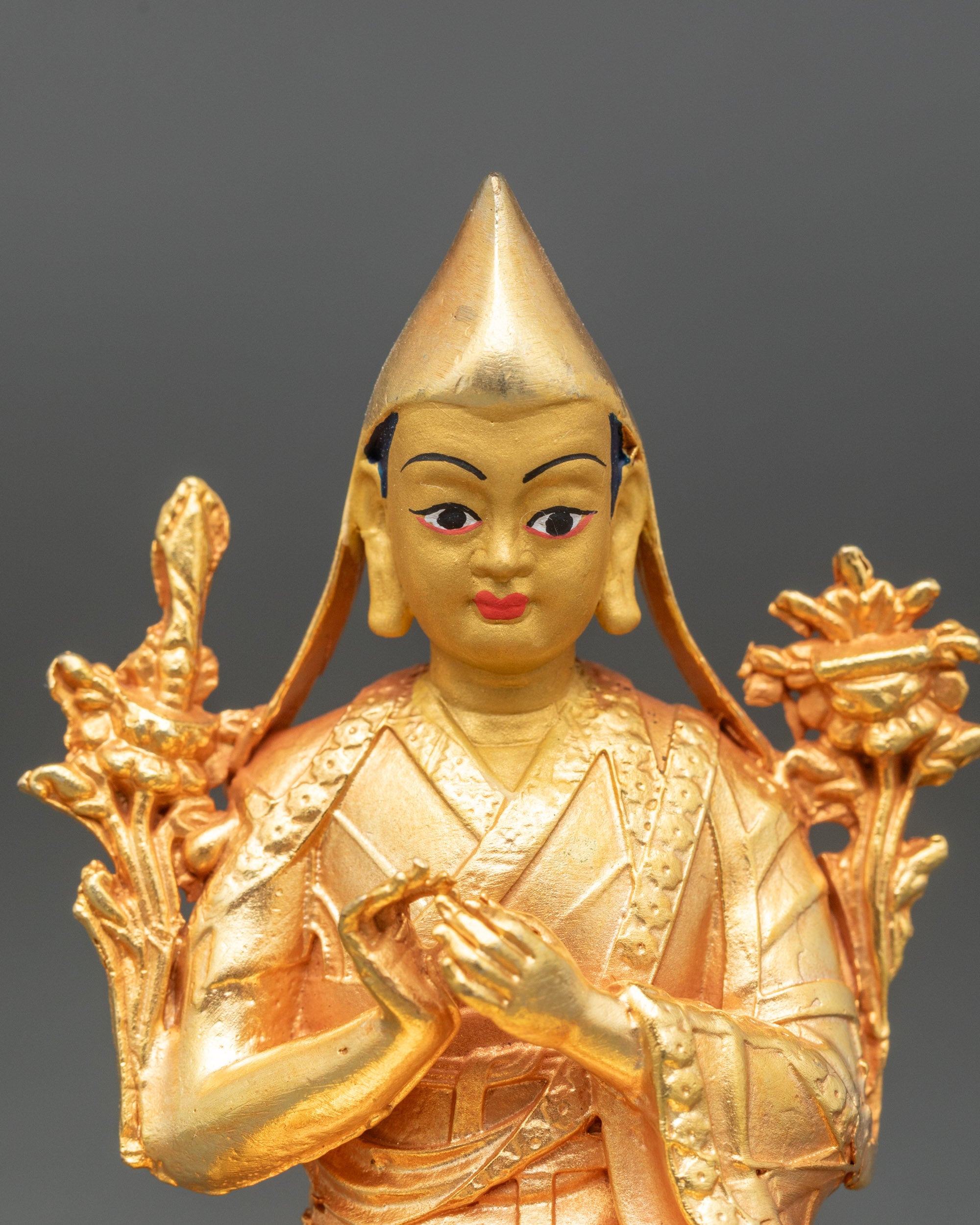 Close-up of Sakya Pandit altar sculpture showing intricate scripture details