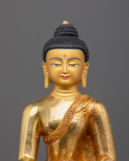 Close-up of Shakyamuni Buddha Statue’s serene face showing intricate gold gilding