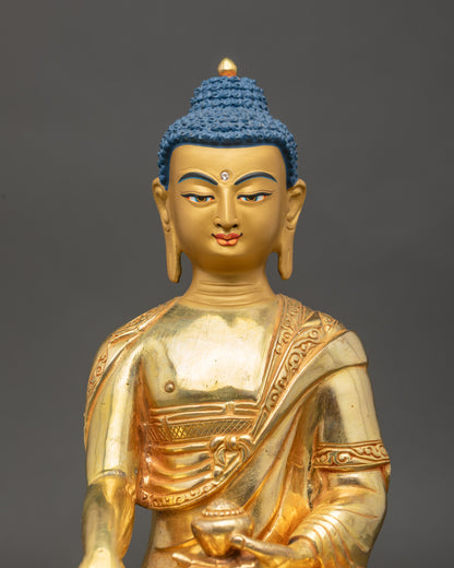 Close-up of Shakyamuni Buddha face with 24K gold finish and serene expression